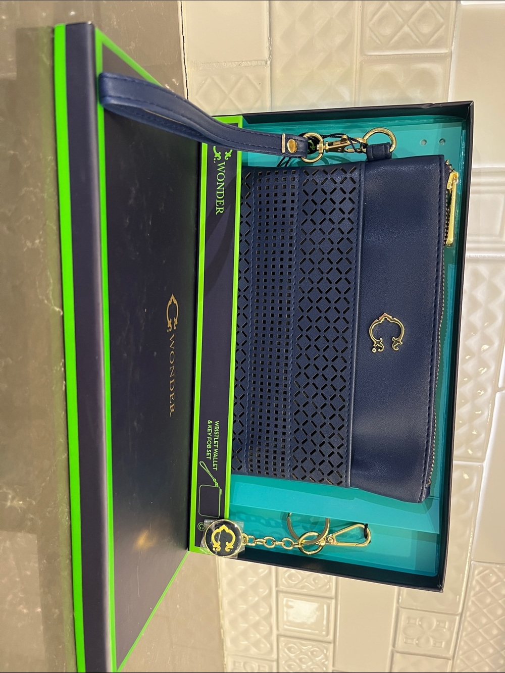 C. Wonder Navy Laser-Cut Wristlet with Gold Hardware
